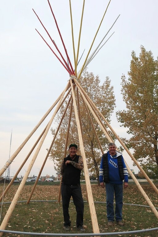 Elder Wilson and Joe Ground erect a tipi at EIPS Central Services