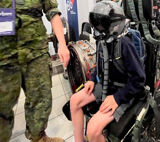 An EIPS student tries a flight helmet on at the Canada-Wide Science Fair’s STEM Expo.