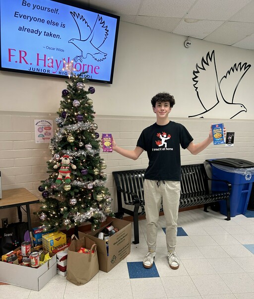 Carsten Gerlack, a Grade 9 student at F.R. Haythorne Junior High, donates items to the school’s holiday food drive.