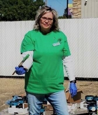 Janet Clarkson, a Success Coach and Registrar at Next Step, helps students from the school and volunteers from DOW Chemical paint two parking stalls for the school’s Pride event.