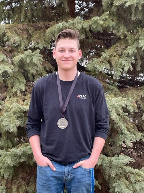 Grade-10-student-poses-with-second-place-medal-for-Skills-Alberta-regional-welding-competition