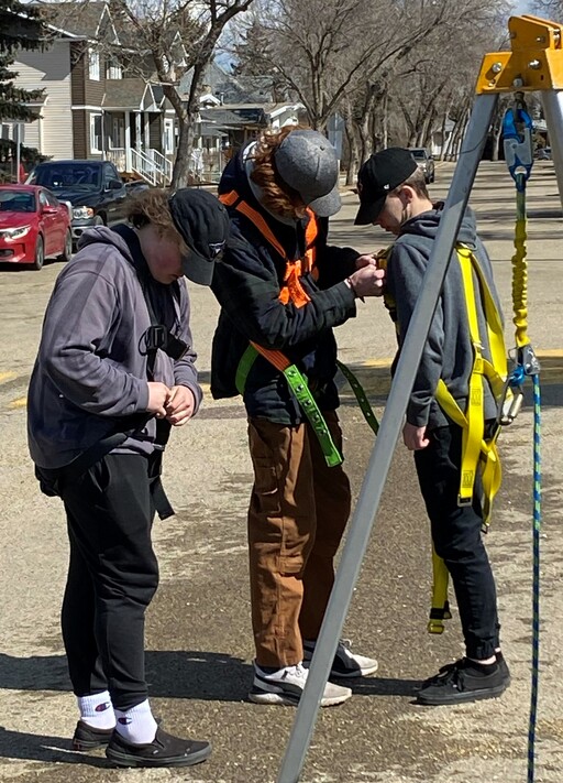 Fort Saskatchewan High students clip in their harnesses during a safety exercise at H2S Alive training.