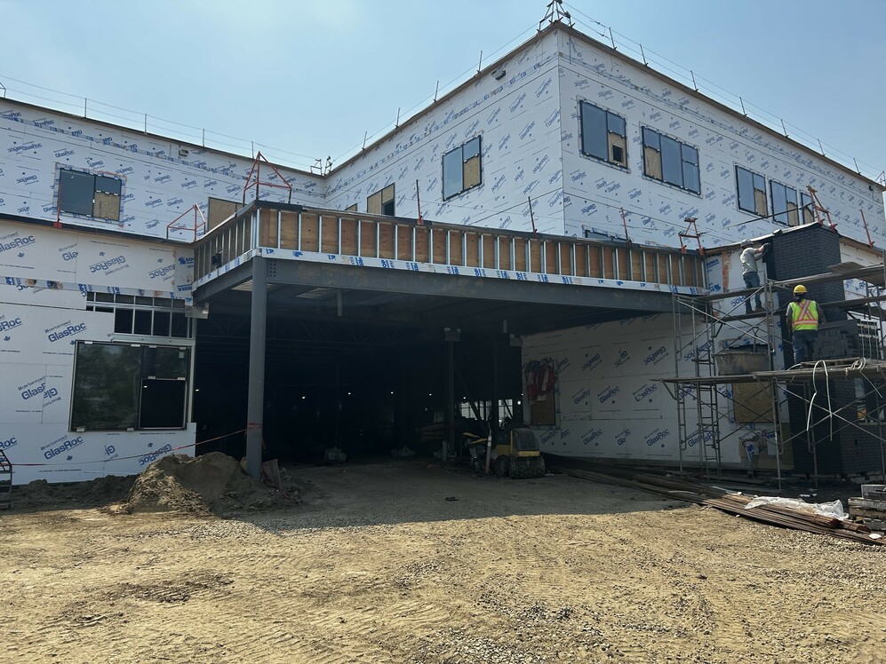 Construction site of a new school building where the front entrance is featured.